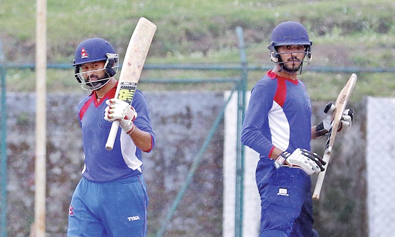 Binod Bhandari of Triton (left) celebrates his century against KCC during the Golden Gate College Cricket League at TU Stadium on Tuesday. Photo: THT