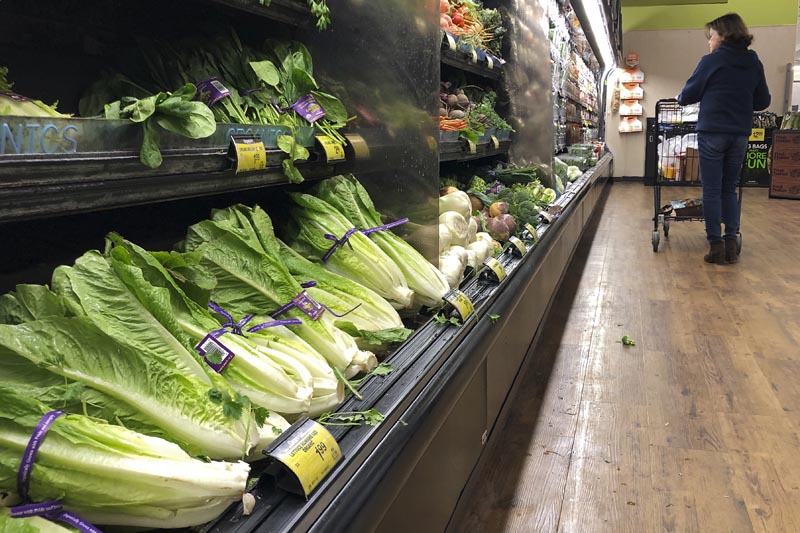FILE: In this November 20, 2018, file photo Romaine lettuce still sits on the shelves as a shopper walks through the produce area of an Albertsons market in Simi Valley, California. Photo: AP/File