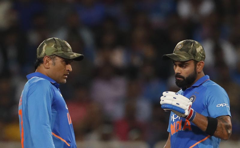 On this photo India's captain Virat Kohli, right, and Mahendra Singh Dhoni interact between the wickets during the third one day international cricket match between India and Australia in Ranchi, India, Friday, March 8, 2019. Photo: AP