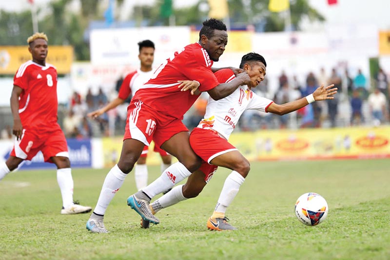 Players of Morang-XI and Nepal APF Club (right) vie for the ball during their fourth Mugmug Jhapa Gold Cup match in Birtamod on Sunday. Photo: THT