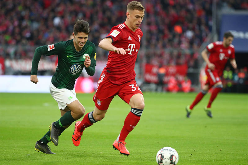 Bayern Munich's Joshua Kimmich in action with VfL Wolfsburg's Josip Brekalo. Photo: Reuters