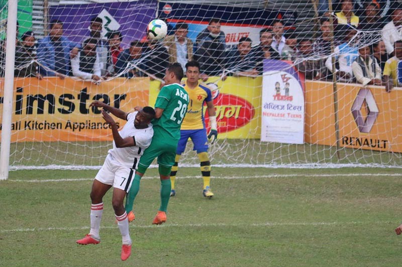 Players of Tribhuvan Army Club and Dauphins Family Club (left) of Cameroon in action during the Mugmug Jhapa Gold Cup at the Domalal Stadium grounds in Birtamod on Saturday, March 9, 2019. Photo: THT