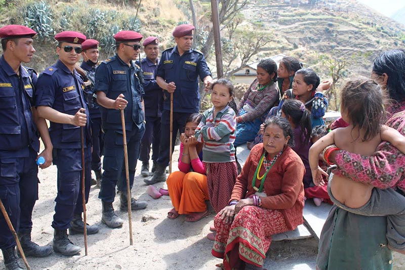 A police team deployed to search for Communist Party of Nepal cadres interrogating locals in Bajura, on Friday, March 22, 2019. Photo: THT