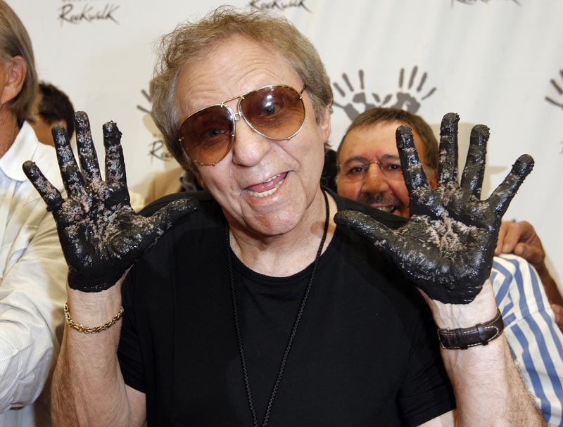 Hal Blaine holds up his hands covered in cement after placing them in wet cement with Don Randi and Glen Campbell, representing The Wrecking Crew following an induction ceremony for Hollywood's RockWalk in Los Angeles on June 25, 2008. Photo: AP/File
