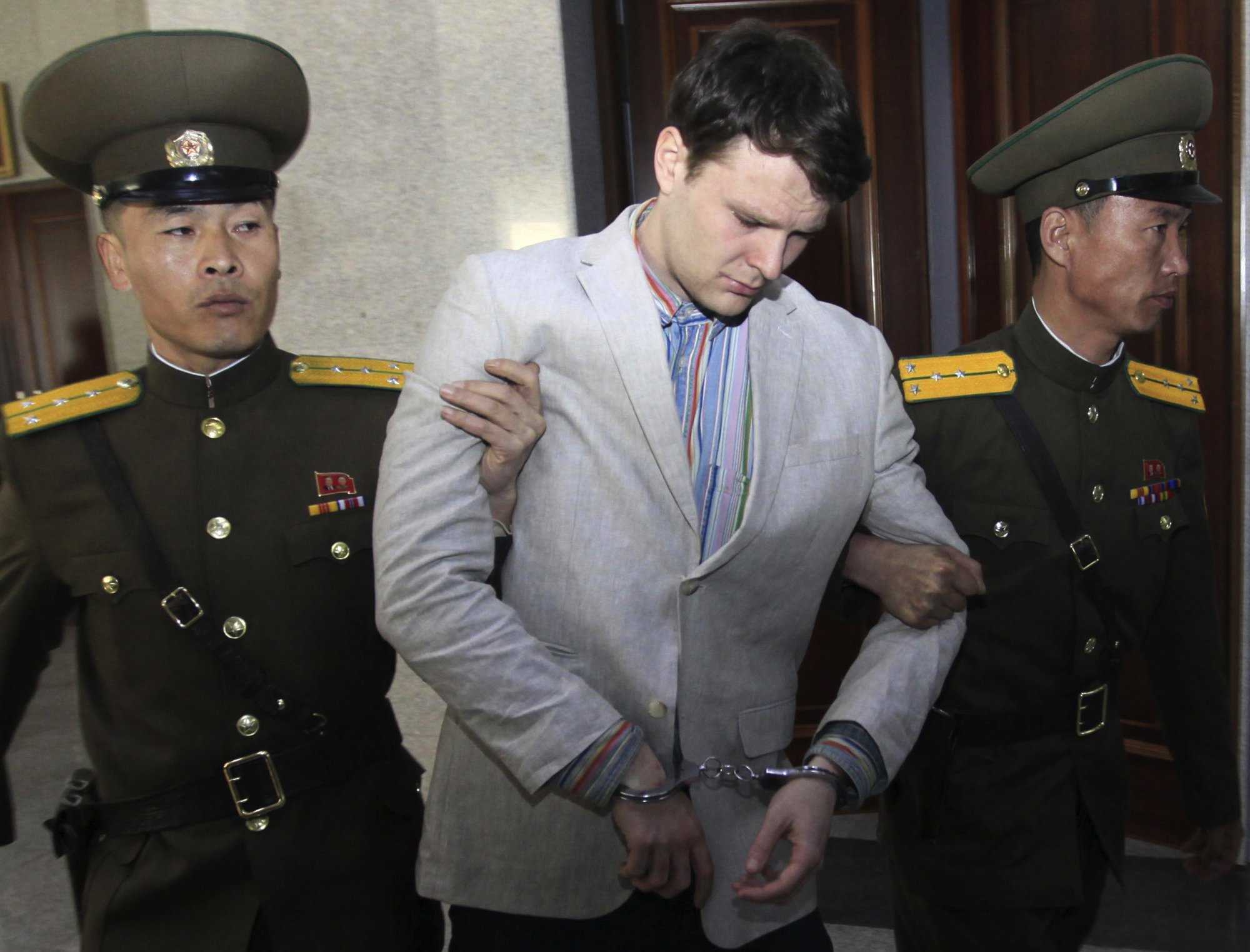 FILE - In this March 16, 2016, file photo, American student Otto Warmbier, center, is escorted at the Supreme Court in Pyongyang, North Korea. Photo: AP