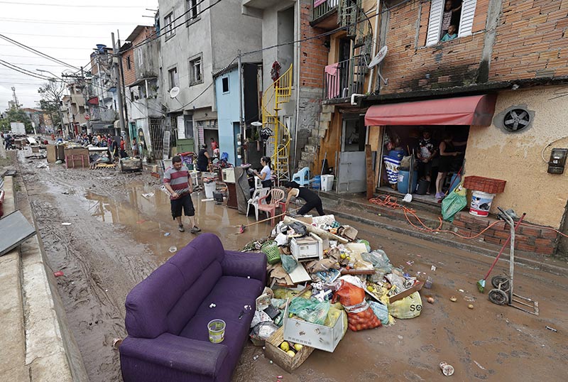Damaged belongings, spoiled food and soaked furniture are piled up in the street to be taken away as trash after flooding in Sao Paulo, Brazil, Monday, March 11, 2019. Photo: AP