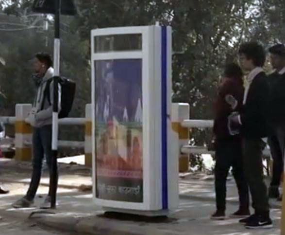 Commuters wait beside a 'smart' dustbin placed at a bus lay-by in Kathmandu. Photo: Nepal Television/Youtube