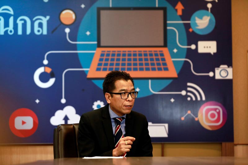 Sawang Boonmee, deputy secretary-general of Election Commission talks as he works in a social media war room in Bangkok, Thailand March 8, 2019. Photo: Reuters