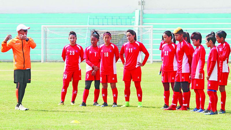 Nepal national women’s football team head coach Hari Khadka lends lesson to players during a training session in Biratnagar on Tuesday, on the eve of their Women’s SAFF Championship semi-final match against Sri Lanka. Photo: Udipt Singh Chhetry / THT