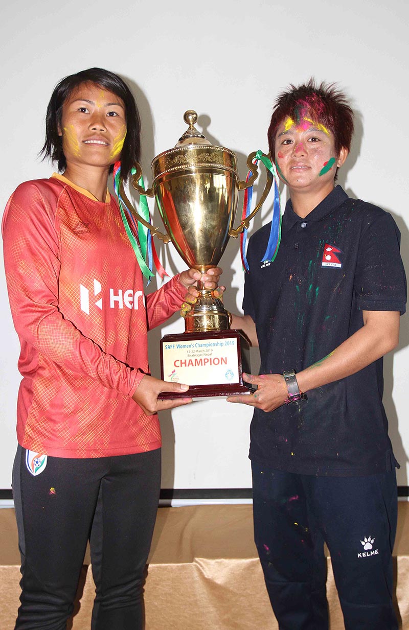 Ashalata Devi Loitongbam (left) and Niru Thapa respectively skippers of India and Nepal take photo with winner’s trophy on the eve of final match during press meet of the SAFF Women’s Championship at Sahhid Rangasala in Biratnagar on Thursday, March 21, 2019. Photo: Udipt Singh Chhetry/ THT