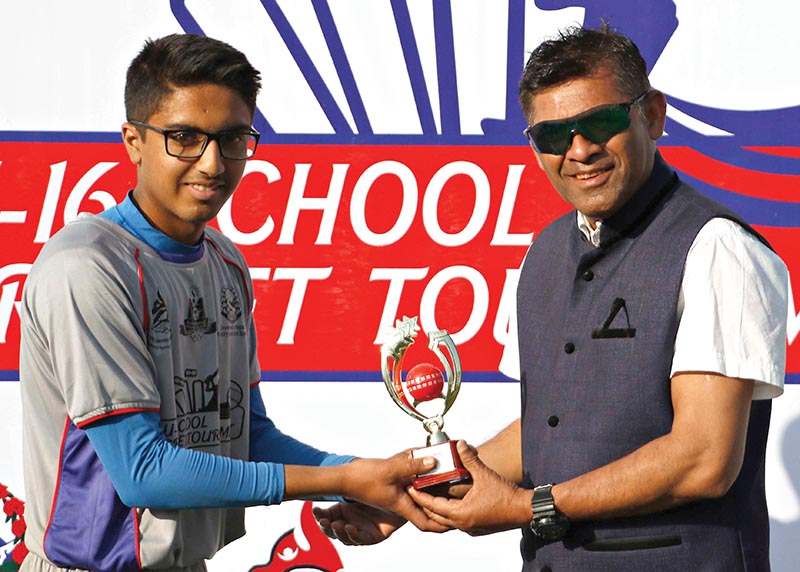 Aaish Bhattarai of Province-3 receives the man of the match award from national team head coach Jagat Tamatta after the U-16 National Cricket Tournament at TU Stadium on Tuesday. Photo: THT