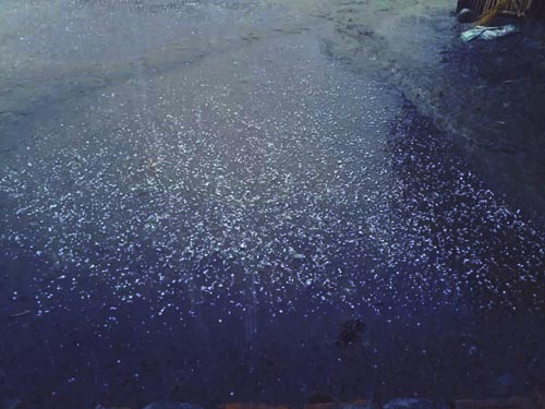FILE - A  view of hailstones accumulated on the road surface during the hailstorm and rain in Pipara area of Jitpur Simara Sub-Metropolitan City-2, in Bara district, on Tuesday, April 9, 2019. Photo: Puspa Raj Khatiwada/THT