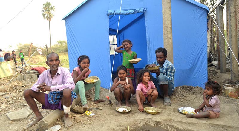 Members of a family hit by the devastating storm eating outside a newly-erected tent at Bhaluhi, Bara, on Friday, April 5, 2019. Photo: THT