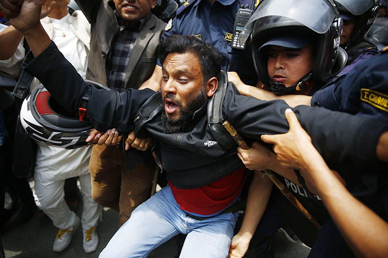 Police arresting a cadre of Bibeksheel Nepali party at a demonstration in front of the prime ministeru2019s residence in Baluwatar, Kathmandu, on Wednesday, April 17, 2019. Illegal sale of the government land to individuals has led to protests.  Photo: Skanda Gautam/THT