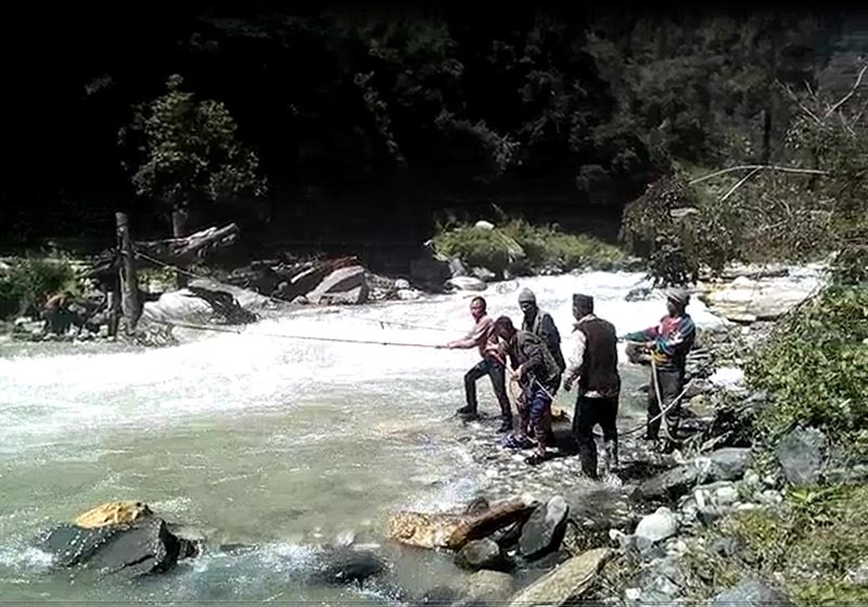 Locals crossing Chhindu River in Himali Rural Municipality-3 of  Bajura district with the help of a rope. Photo: Prakash Singh/THT