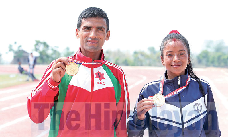 Marathon winners Krishna Basnet and Rajpura Pachhai hold gold medals, under the eighth National Games on Monday. Photo: Udipt Singh Chhetry / THT