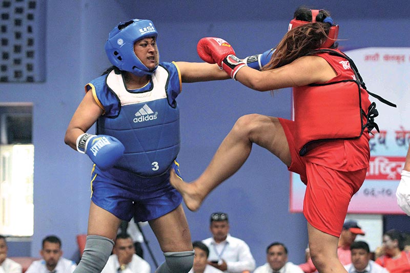 Shilu Dangol (left) of Tribhuvan Army Club fights against Anisha Ale Magar of Gandaki Province in women's 75kg final bout in Sanshou of Wushu at covered hall of Nepalgunj Stadium in Nepalgunj on Tuesday. Photo: Udipt Singh Chhetry/ THT