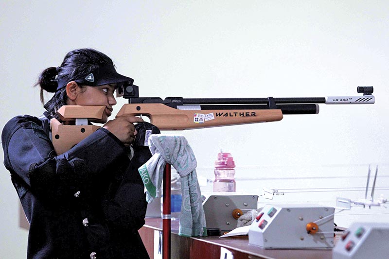 Shushmita Nepal of Province-3 aims target during the womenu2019s 10-metre air rifle finals of the National Shooting Tournament under the eighth National Games in Banke on Tuesday. Photo: THT