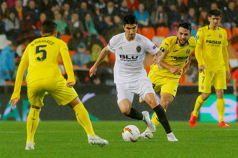 Valencia's Carlos Soler in action with Villarreal's Santiago Caseres. Photo: Reuters