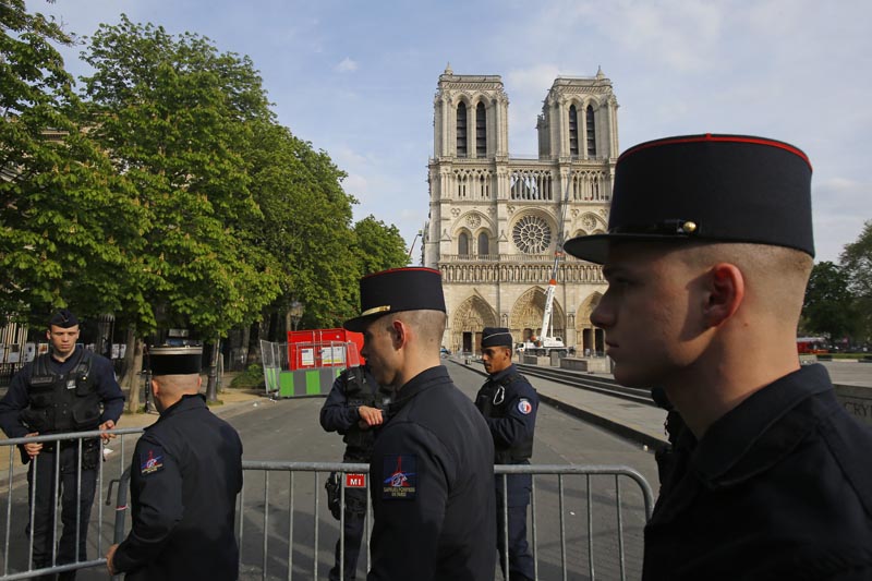 Members of Paris Firefighters' brigade enter the security perimeter to Notre Dame cathedral Thursday, April 18, 2019 in Paris. Photo: AP