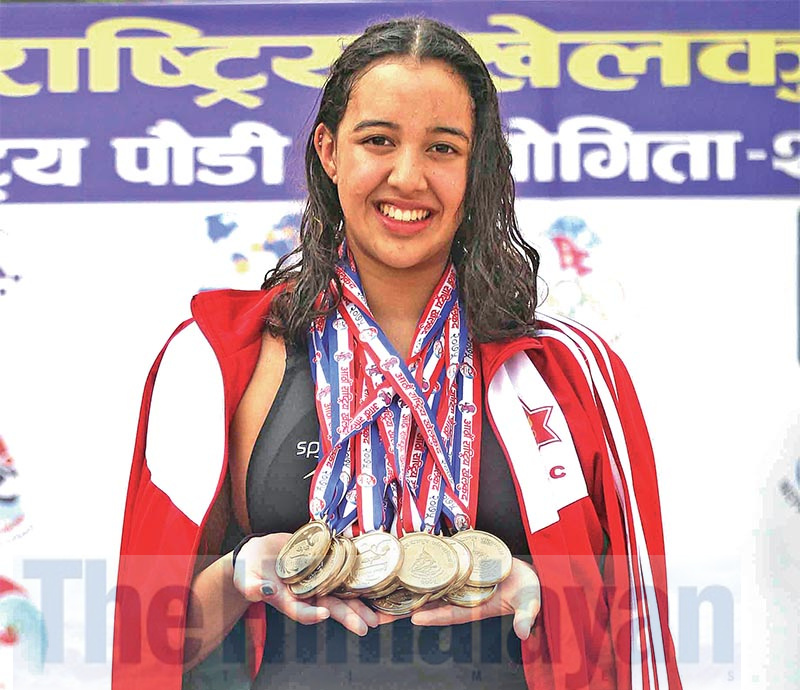 Gaurika Singh of Tribhuvan Army Club pose with her 12 gold medals in victory stand after medal ceremony in swimming championship of the 8th National Games at Cygnett Hotel swimming pool in Nepalgunj on Wednesday. Photo: Udipt Singh Chhetry/ THT