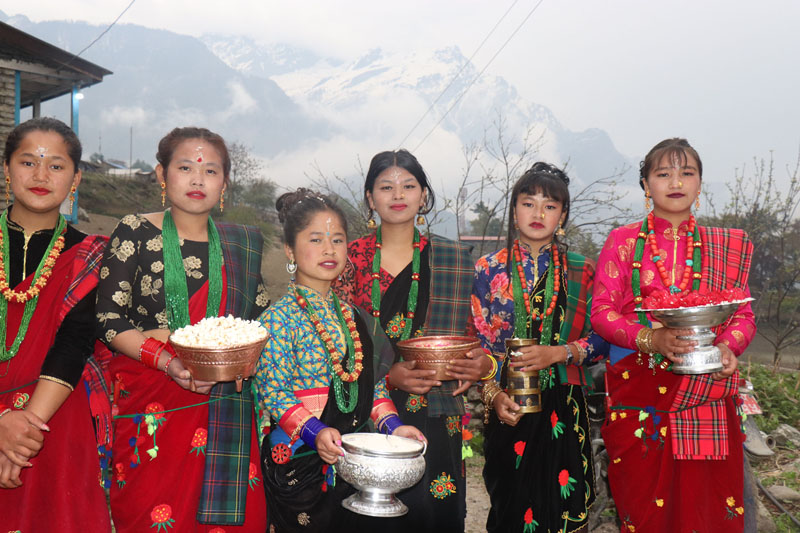 Girls in traditional attire wait to welcome tourists visiting homestay to celebrate New Year at Tachai, in Naso Rural Municipality-8 of Manang district, on Tuesday, April 16, 2019. Photo: RSS