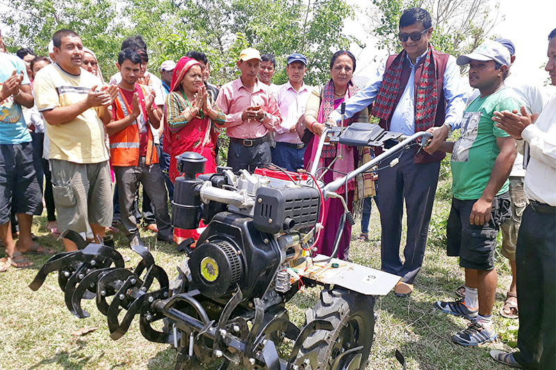 Triyuga Municipality offcial handing over hand tractor to farmer in Udayapur district, on Friday, April 12, 2019. Photo: Shyam Rai/THT