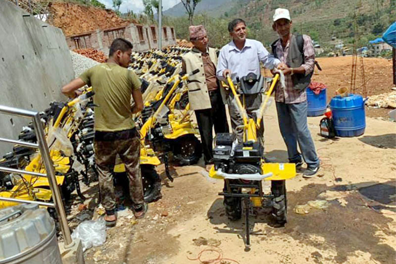 Officials handing over hand tractors to farmers in Dhading district today. Photo: Keshav Adhikari/THT