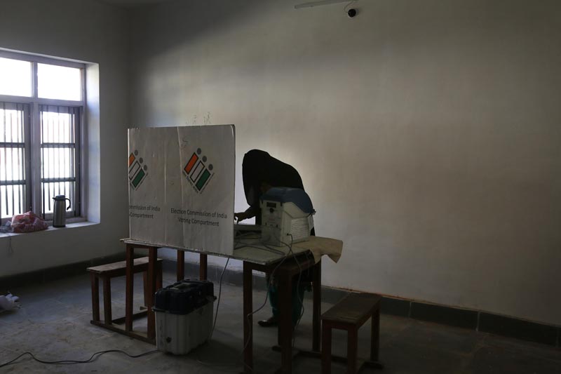 A Kashmir burqa clad woman casts her vote inside a polling station during the third phase of India's general elections, at Verinag, south of Srinagar, Indian controlled Kashmir, Tuesday, April 23, 2019. Photo: AP