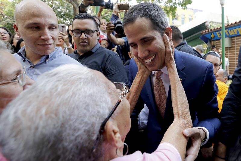 Juan Guaido, Venezuelan opposition leader and self-proclaimed interim president, is greeted by a supporter as he leaves a meeting at a university in Caracas, Venezuela, Monday, April 1, 2019.Photo: AP