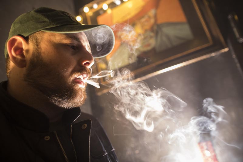 In this Friday, March 29, 2019 photo, a man smokes marijuana at a Spleef NYC canna-cocktail party in New York. Photo: AP