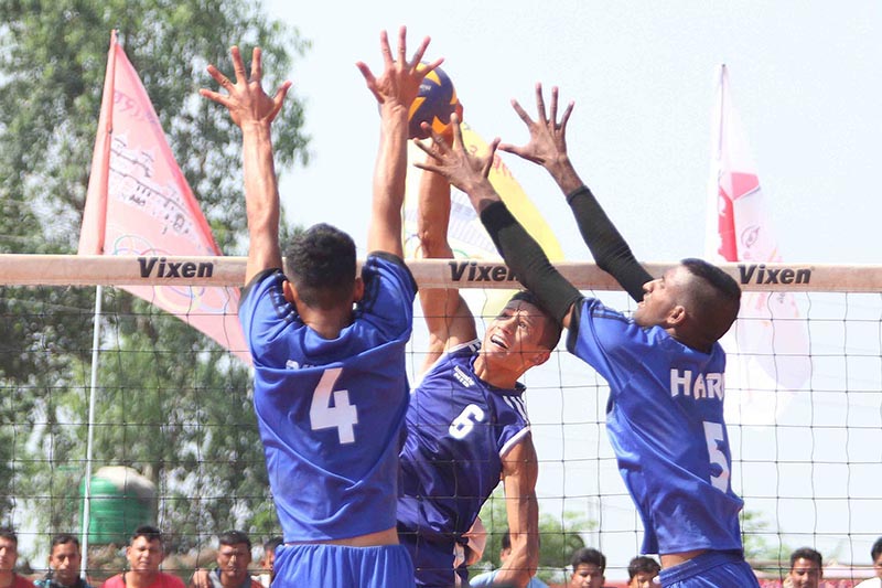 Dhan Bahadur Bhatta (centre) of TAC jumps for a spike against Gandaki Province players during their men’s volleyball match, under the eighth National Games on Friday, April 19, 2019. Photo: Udipt Singh Chhetry/THT