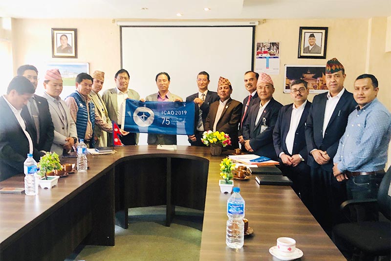 Minister of State for Culture, Tourism and Civil Aviation Dhan Bahadur Budha and other officials at the ministry hands over a flag of International Civil Aviation Organisation to the Nepal Mountaineering Association with a message that Nepal is a safe destination for the world travellers, at MoCTCA, in Kathmandu, on Sunday, April 21, 2019. Photo: MoCTCA