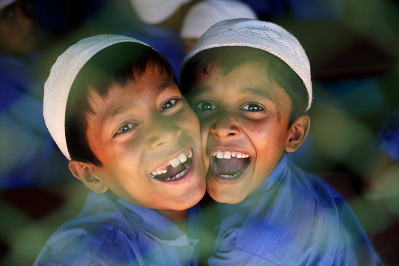 Rohingya refugee boys who study in an Islamic school smile as they react to the camera at a refugee camp in Cox's Bazar, Bangladesh, on April 9, 2019. Photo: Reuters