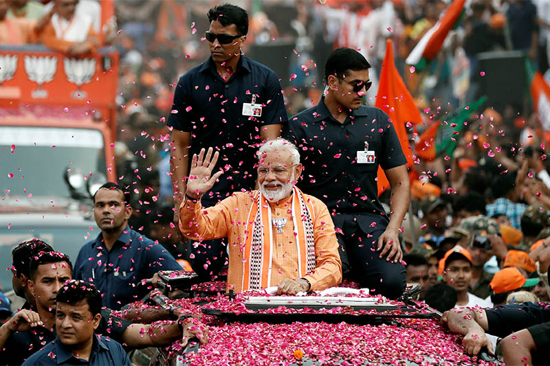 India's Prime Minister Narendra Modi waves towards his supporters during a roadshow in Varanasi, India, April 25, 2019. Photo: Reuters