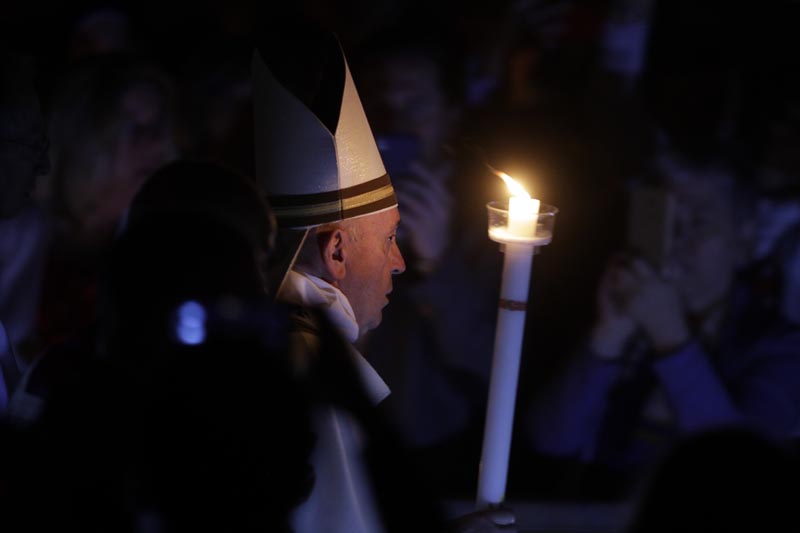 Pope Francis holds a candle as he presides over a solemn Easter vigil ceremony in St Peter's Basilica at the Vatican, Saturday, April 21, 2019. Photo: AP