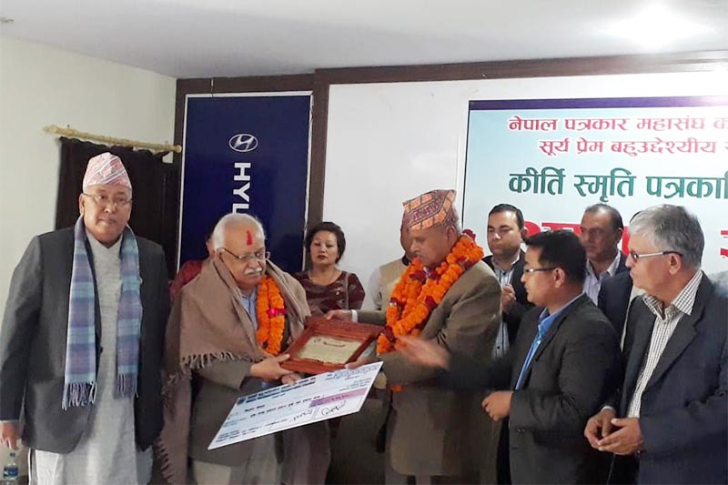 Former president Ram Baran Yadav honouring senior journalist Kishor Nepal with an award in Pokhara, on Tuesday, April 2, 2019. Photo: THT