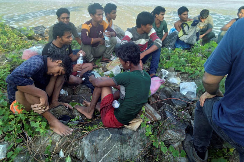 Dozens of people, believed to be Rohingya Muslims from Myanmar who were dropped off from a boat are pictured on a beach near Sungai Belati, Perlis, Malaysia in this undated handout photo released April 8, 2019. Photo: Royal Malaysian Police/Handout via Reuters