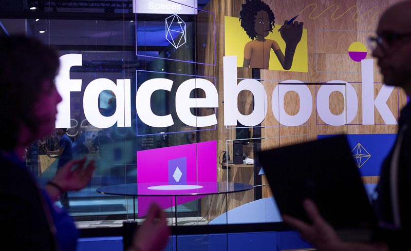 FILE: In this April 18, 2017 file photo, conference workers speak in front of a demo booth at Facebook's annual F8 developer conference, in San Jose, California. Photo: AP