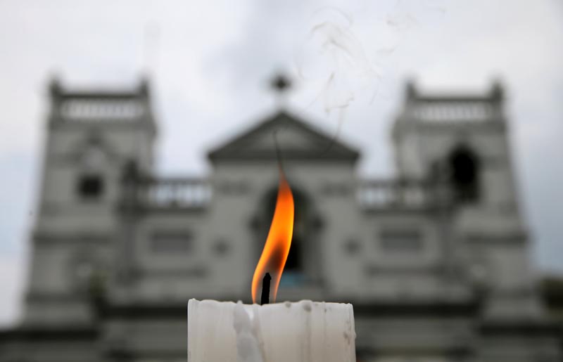 A candle burns outside St Anthony's Shrine a week after a string of suicide bomb attacks across the island on Easter Sunday, in Colombo, Sri Lanka April 28, 2019. Photo: Reuters