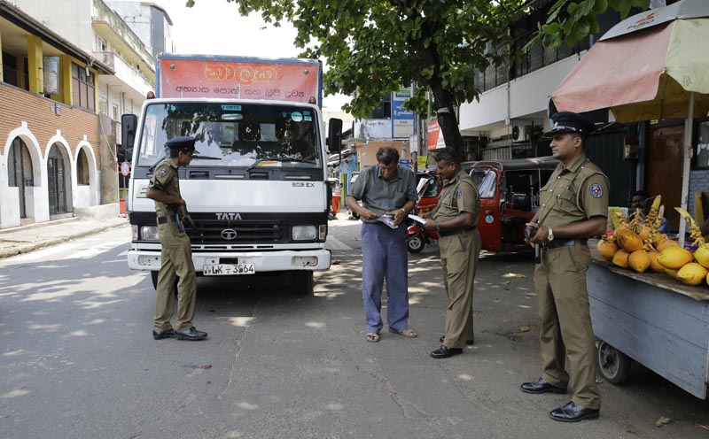 Sri Lankan police officers perform security checks on a truck at a roadside in Colombo, Sri Lanka, Thursday, April 25, 2019. Photo: AP