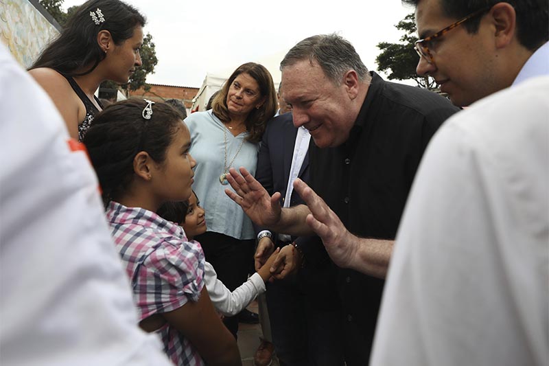 US Secretary of State Mike Pompeo (right) greets a young Venezuelan migrant at a migrant shelter, as he's given a tour by Colombian Vice President Marta Lucia Ramirez, behind, and Colombian President Ivan Duque, not in picture, in La Parada near Cucuta, Colombia, on the border with Venezuela, on Sunday, April 14, 2019. Photo: AP