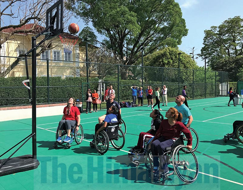 UK Sports President and five-time Olympic Games medallist Dame Katherine Grainger (left) and British Ambassador to Nepal Richard C Morris taking part in a wheelchair basketball game with para-taekwondo players of Nepal, during a programme in Kathmandu on Monday.