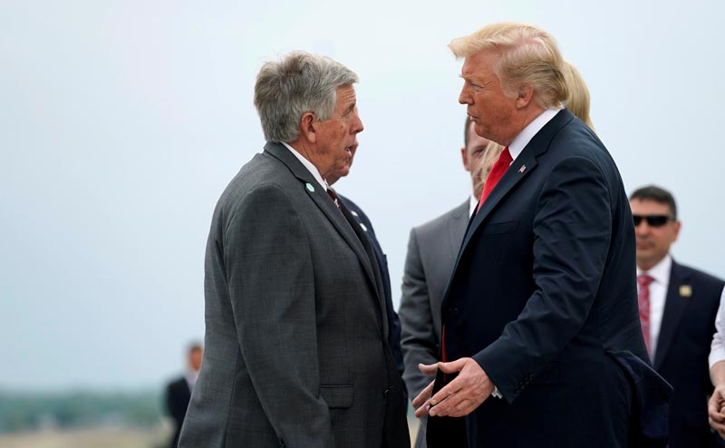FILE: US President Donald Trump speaks with the Governor of Missouri Mike Parson as he arrives in St Louis, Missouri, US, July 26, 2018. Photo: Reuters