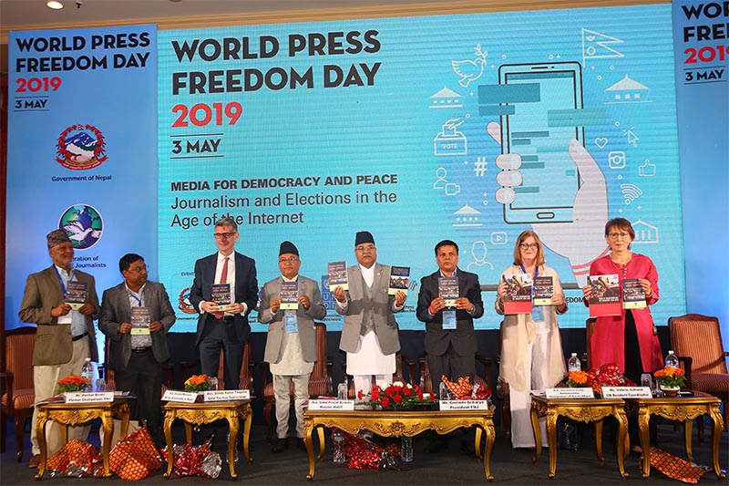 Minister of Communications and Information Technology Gokul Prasad Banskota releasing the annual report of FNJ, in Kathmandu, on Friday, May 3, 2019. Photo: RSS