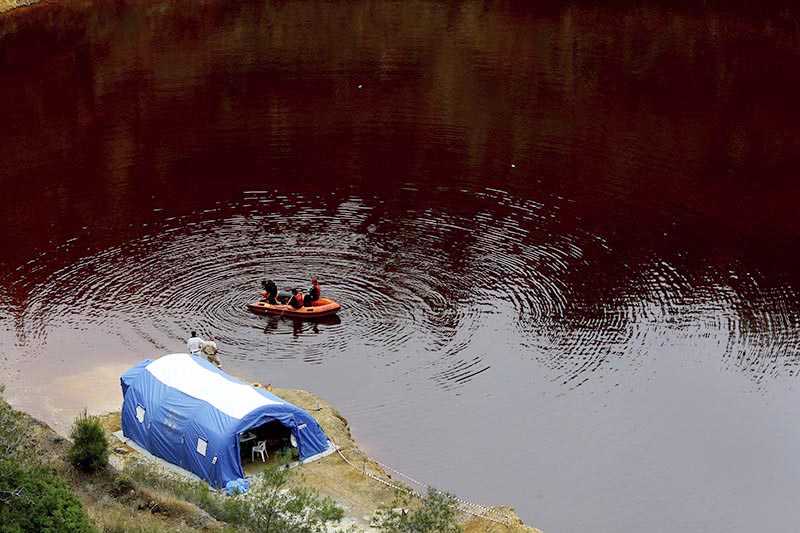 Members of the Cyprus Special Disaster Response Unit search for suitcases in a man-made lake, near the village of Mitsero outside of the capital Nicosia, Cyprus, on Wednesday, May 1, 2019. Cyprus police spokesman Andreas Angelides says British experts called in to assist in the east Mediterranean island nation's serial killer case have been brought up to speed on the ongoing probe. Photo: AP