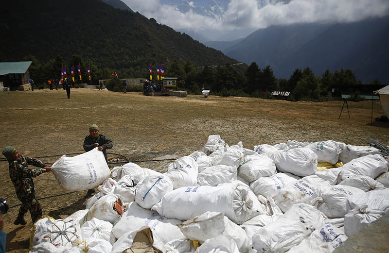 Nepal Army personnel pile up sacks of garbage collected from the high camps of Mount Everest during the Everest Clean-up Campaign at Namche Bazaar, on Monday, May 27, 2019. Photo: Skanda Gautam/THT