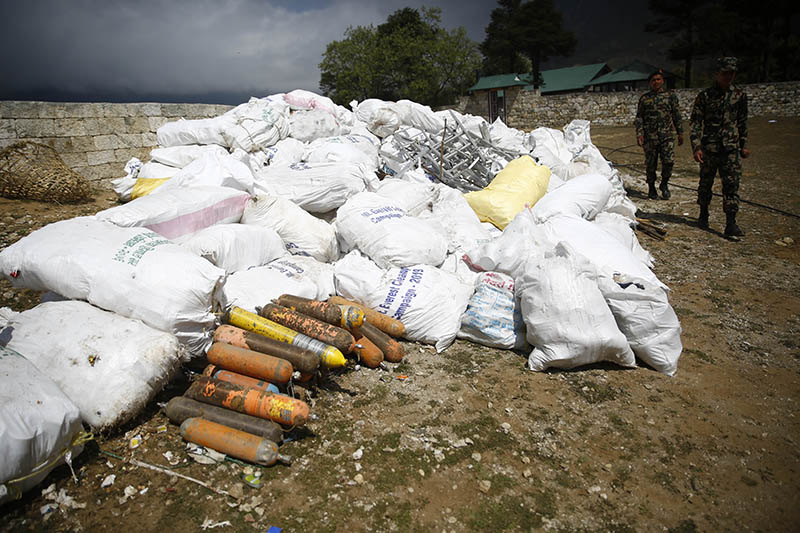 Nepal Army personnel walk past the garbage collected from the high camps of Mount Everest during the Everest Clean-up Campaign at Namche Bazaar, on Monday, May 27, 2019. Photo: Skanda Gautam/THT