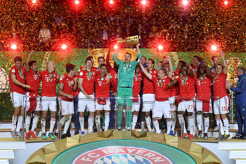 Bayern Munich's Manuel Neuer celebrates winning the DFB Cup with team mates. Photo: Reuters