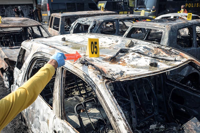 Investigators work at the scene of cars set on fire by protesters at Brimob (Mobile Police) Dormitory Complex, Petamburan, Jakarta, Indonesia, May 22, 2019 in this photo taken by Antara Foto. Photo: Antara Foto/Aprillio Akbar/ via Reuters